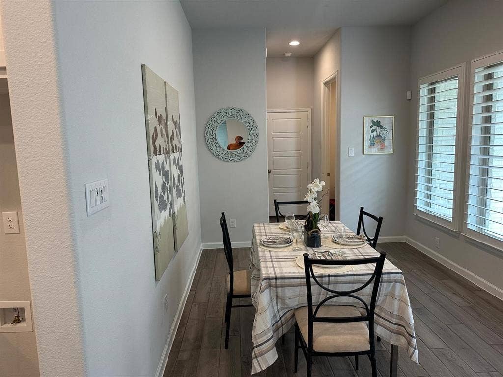 5308 Tupper Avenue, Fate, TX 75087 Wood-finish flooring, recessed lighting, and multiple windows with plantation shutters