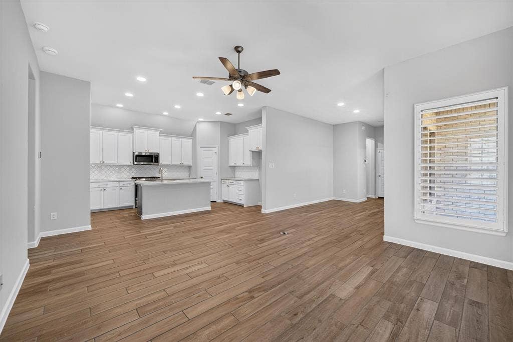 5308 Tupper Avenue, Fate, TX 75087 Open concept living area featuring wood-finish flooring, recessed lighting, and a ceiling fan