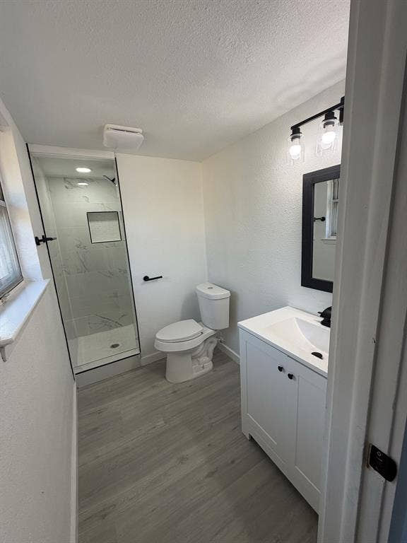 806 S Atkerson Lane, Euless, TX 76040 White vanity with integrated sink, black framed mirror, and track lighting