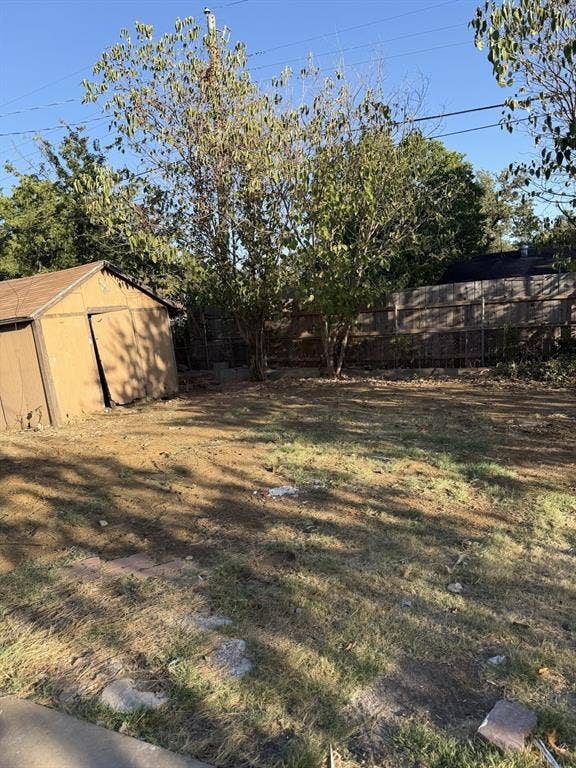 806 S Atkerson Lane, Euless, TX 76040 Expansive yard featuring mature trees and a wood-sided storage shed