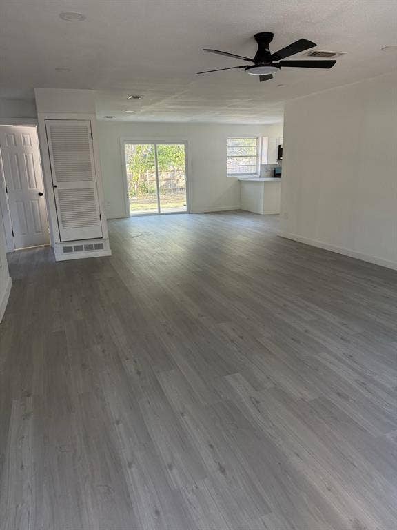 806 S Atkerson Lane, Euless, TX 76040 Spacious room featuring wood-finish flooring, white walls, and a black ceiling fan
