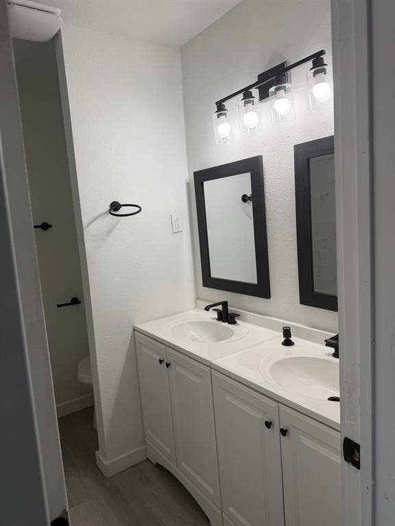 806 S Atkerson Lane, Euless, TX 76040 Bathroom with dual sinks, matte black hardware, and framed mirrors