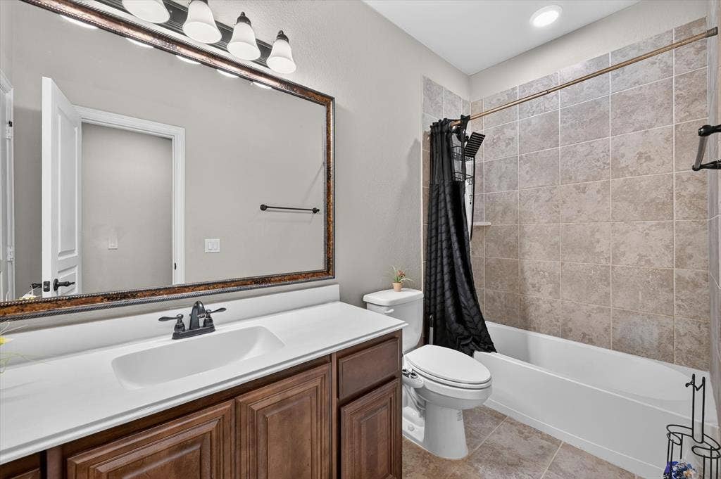 316 Jernigan Drive, Euless, TX 76040 Bathroom 3 Wood-finish vanity with an integrated sink and matte black faucet