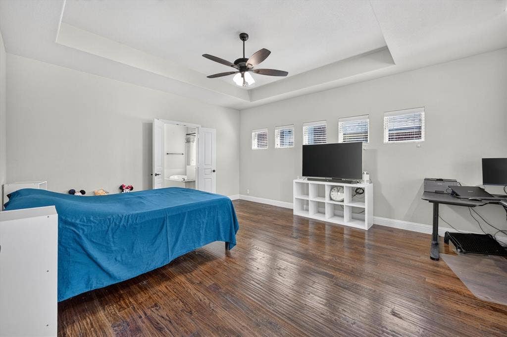 316 Jernigan Drive, Euless, TX 76040 Tray ceiling with a ceiling fan, dark wood-finish flooring, and multiple windows