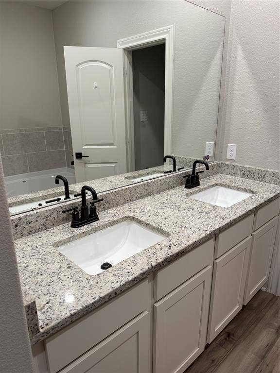 1001 Calhoun Drive, Anna, TX 75409 Dual vanity with granite-style countertop, undermount sinks, and matte black fixtures
