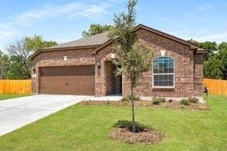 1001 Calhoun Drive, Anna, TX 75409 Brick exterior with an arched entry, attached two-car garage, concrete driveway, and established lawn
