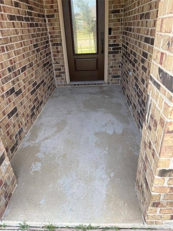 1001 Calhoun Drive, Anna, TX 75409 Brick exterior with a brown paneled entry door featuring a full-light glass insert