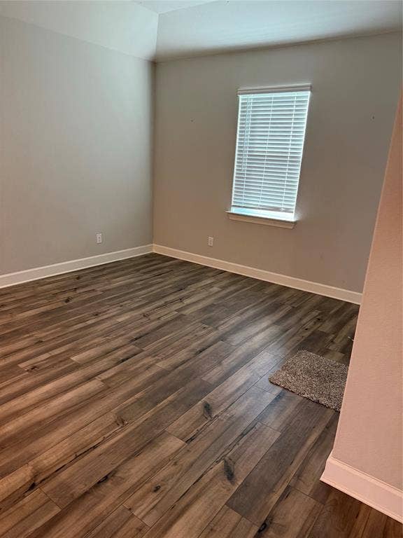 1001 Calhoun Drive, Anna, TX 75409 Wood-finish flooring with white trim, light gray wall tones, and a window with blinds