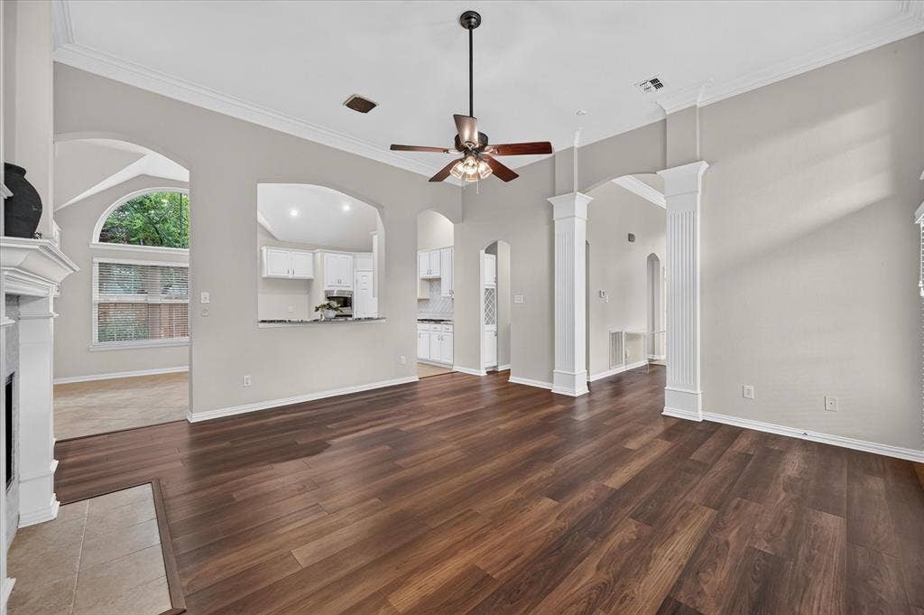10307 Perkins Drive, Irving, TX 75063 Wood-finish flooring, crown molding, and an arched entryway