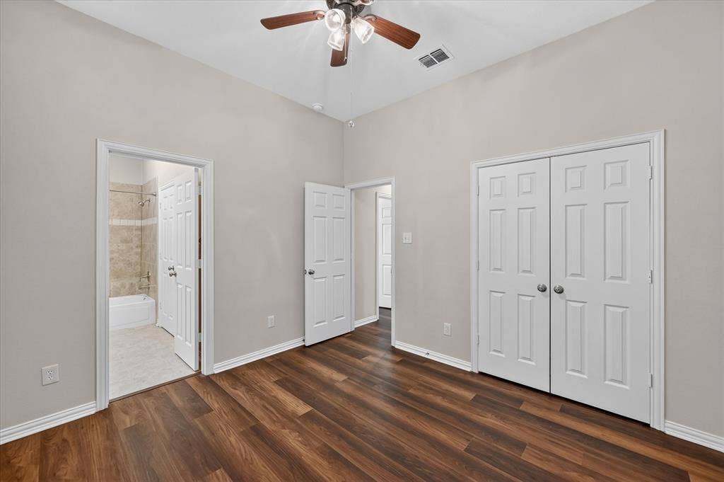 10307 Perkins Drive, Irving, TX 75063 Wood-finish flooring, vaulted ceiling with a ceiling fan, and white paneled doors