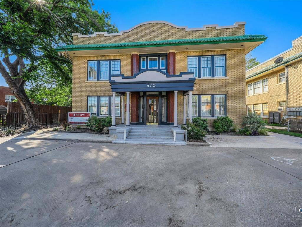 4310 Gaston Avenue, #103, Dallas, TX 75246 Two-story building featuring brick construction, a covered main entrance, and multiple windows