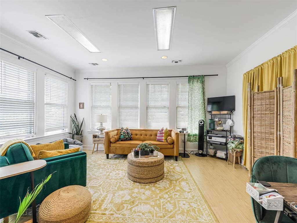 4310 Gaston Avenue, #103, Dallas, TX 75246 Recessed lighting, wood-finish flooring, multiple windows with blinds, and crown molding