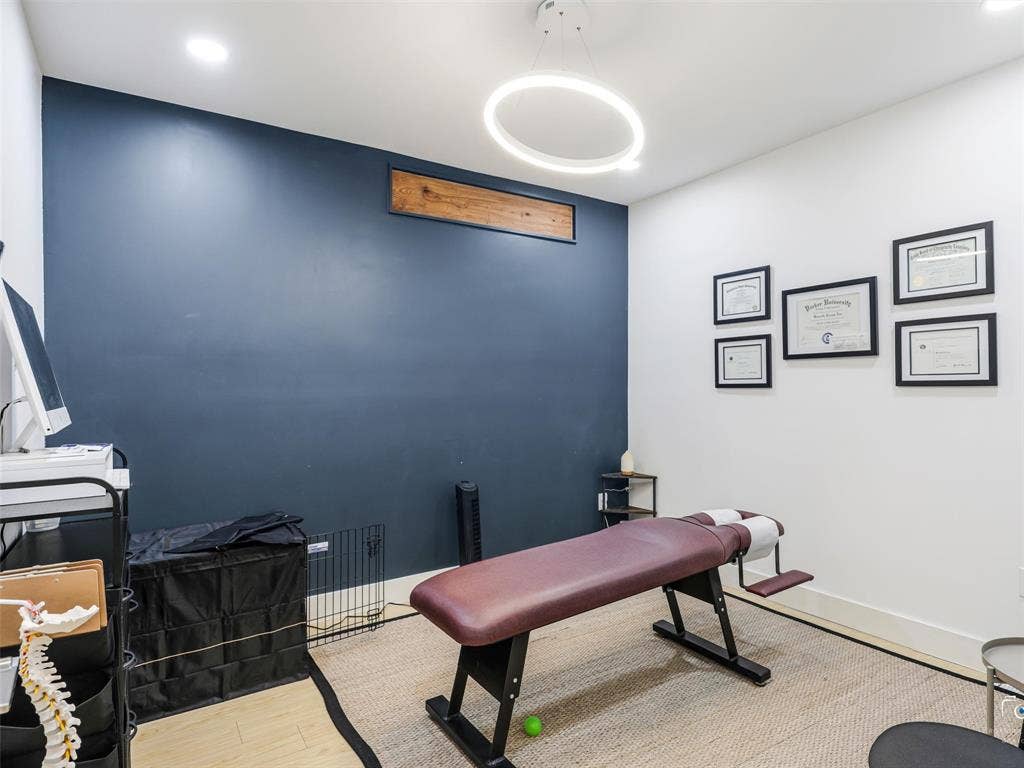 4310 Gaston Avenue, #103, Dallas, TX 75246 Accent wall with dark blue paint, recessed lighting, and a circular overhead light fixture