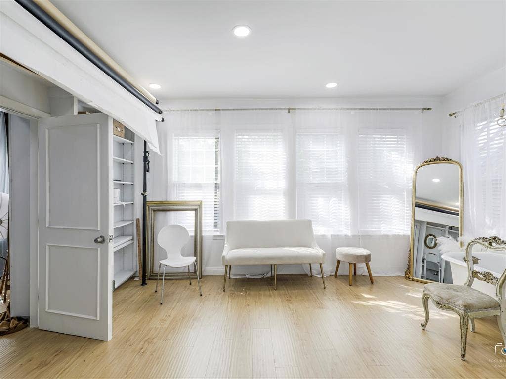 4310 Gaston Avenue, #103, Dallas, TX 75246 Recessed lighting, wood-finish flooring, white paneled door, built-in shelving, multiple windows with blinds