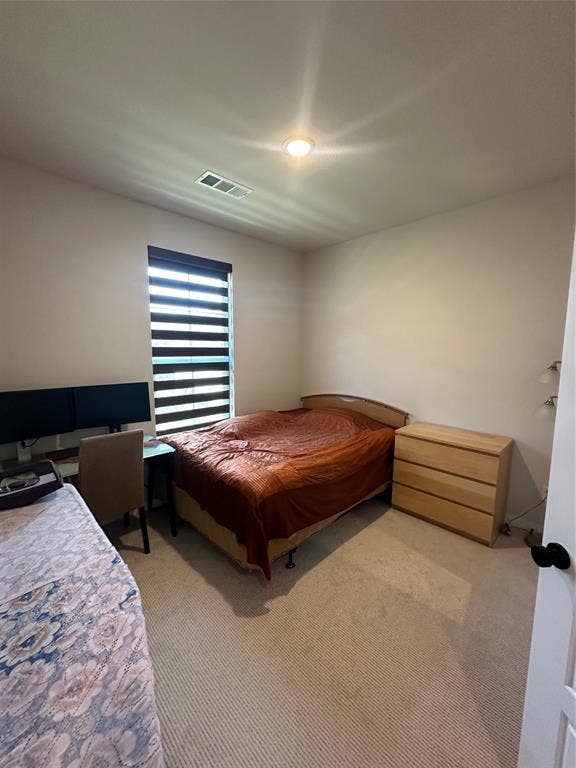 Carpeted flooring with recessed lighting and a window featuring horizontal blinds