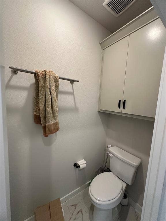 Built-in upper cabinetry, ceiling-mounted ventilation, and tile flooring