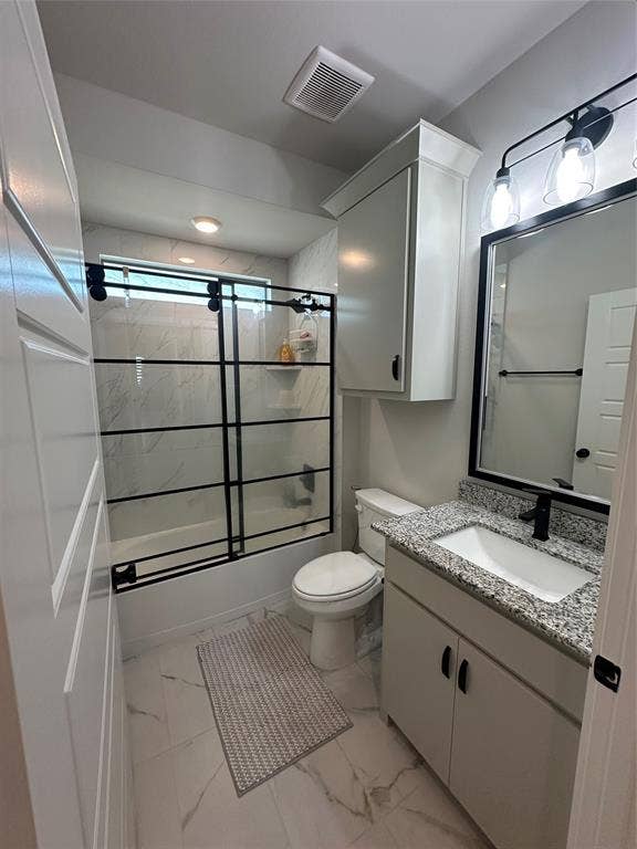 Bathroom featuring a built-in vanity with granite-finish countertop, a rectangular undermount sink, and a black-framed mirror