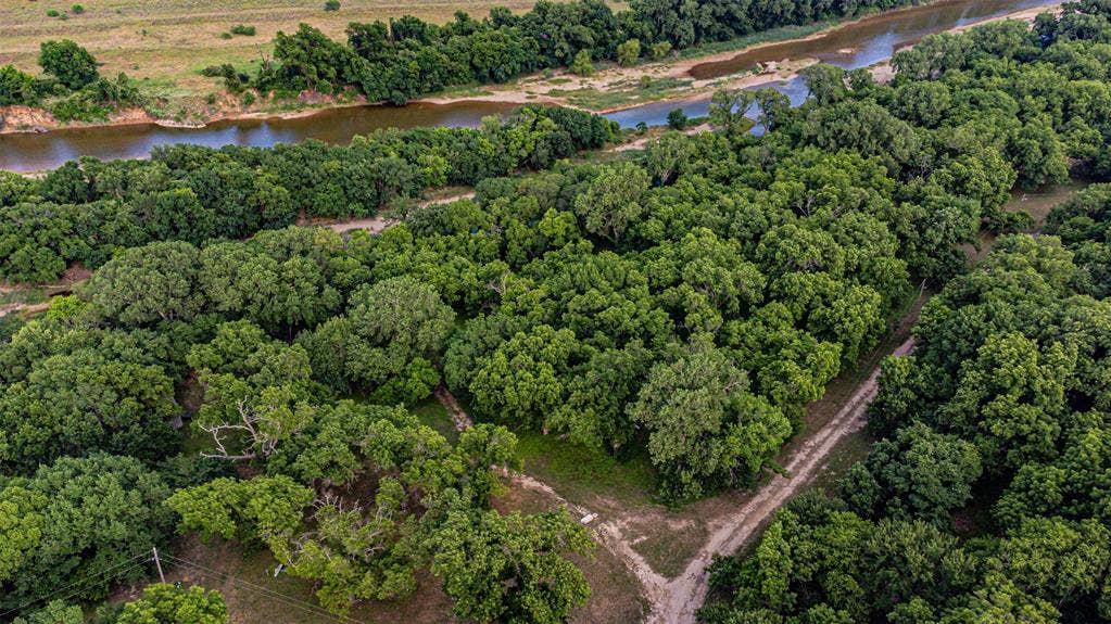 3018 River View Court, Granbury, TX 76048 Expansive forested acreage featuring dense tree cover and a winding river