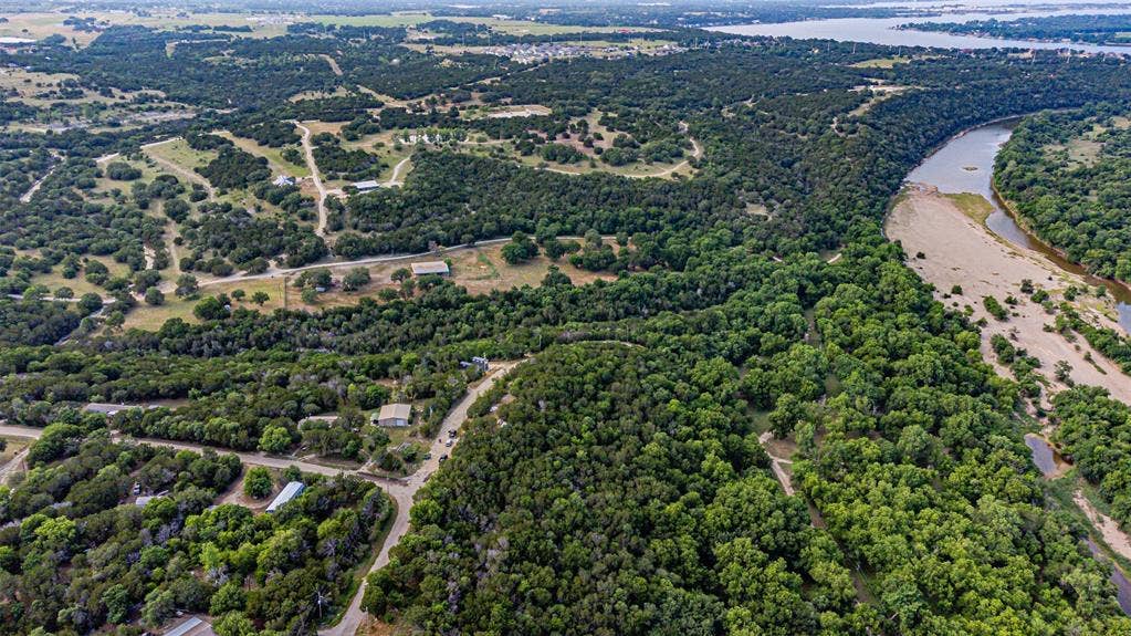 3018 River View Court, Granbury, TX 76048 Expansive natural landscape featuring a winding river, dense tree coverage, and a distant body of water