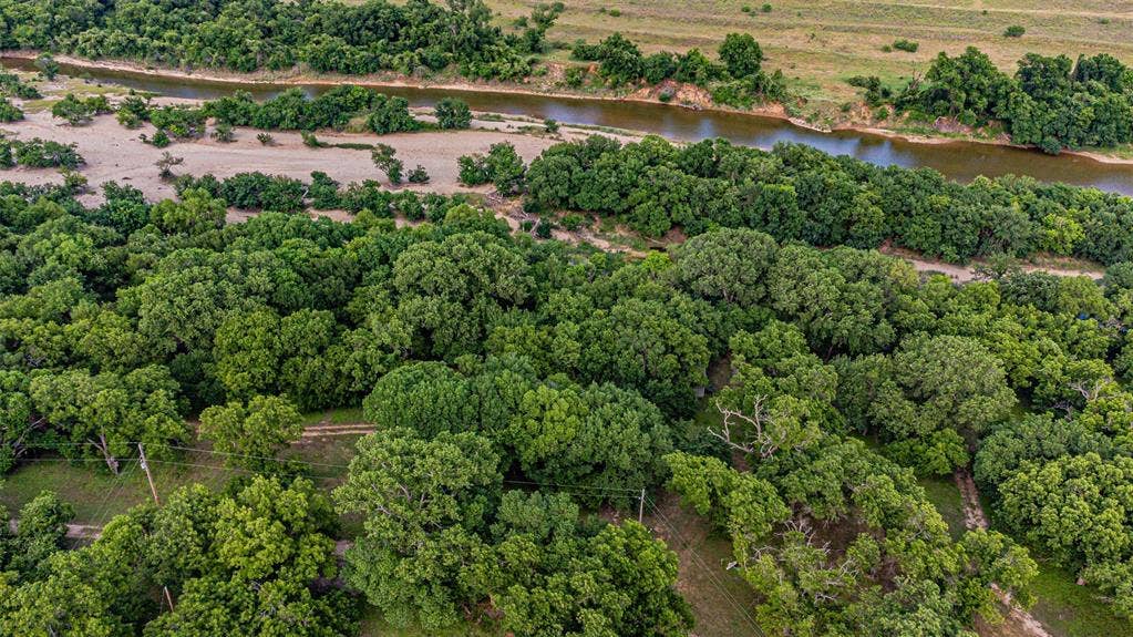 3018 River View Court, Granbury, TX 76048 Lush tree coverage with a winding river and expansive natural terrain