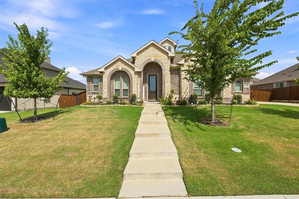 5225 Rowlan Row, Midlothian, TX 76065 Brick and stone façade with arched entryway