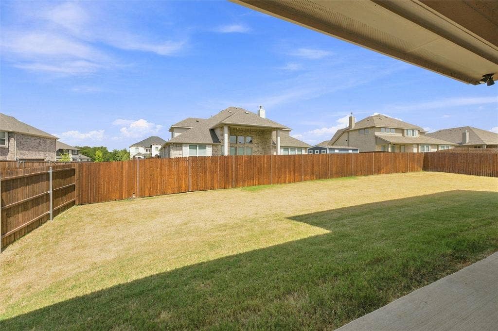 5225 Rowlan Row, Midlothian, TX 76065 Expansive backyard with a wood privacy fence and a concrete patio
