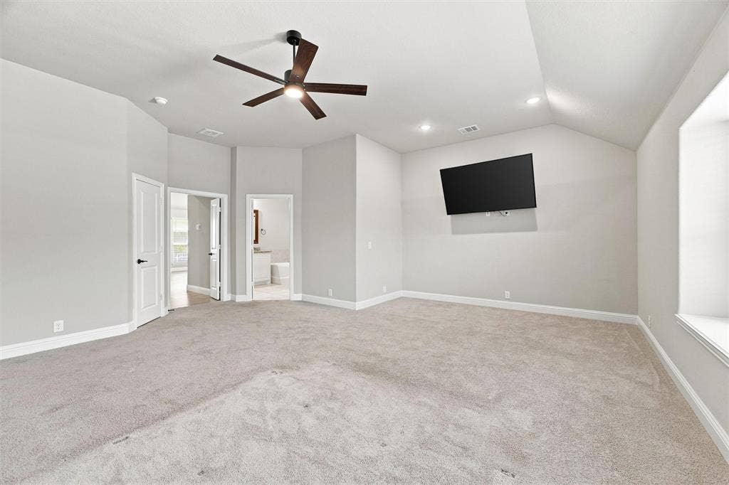 5225 Rowlan Row, Midlothian, TX 76065 Spacious room featuring vaulted ceilings, recessed lighting, a modern ceiling fan, and light gray carpeting
