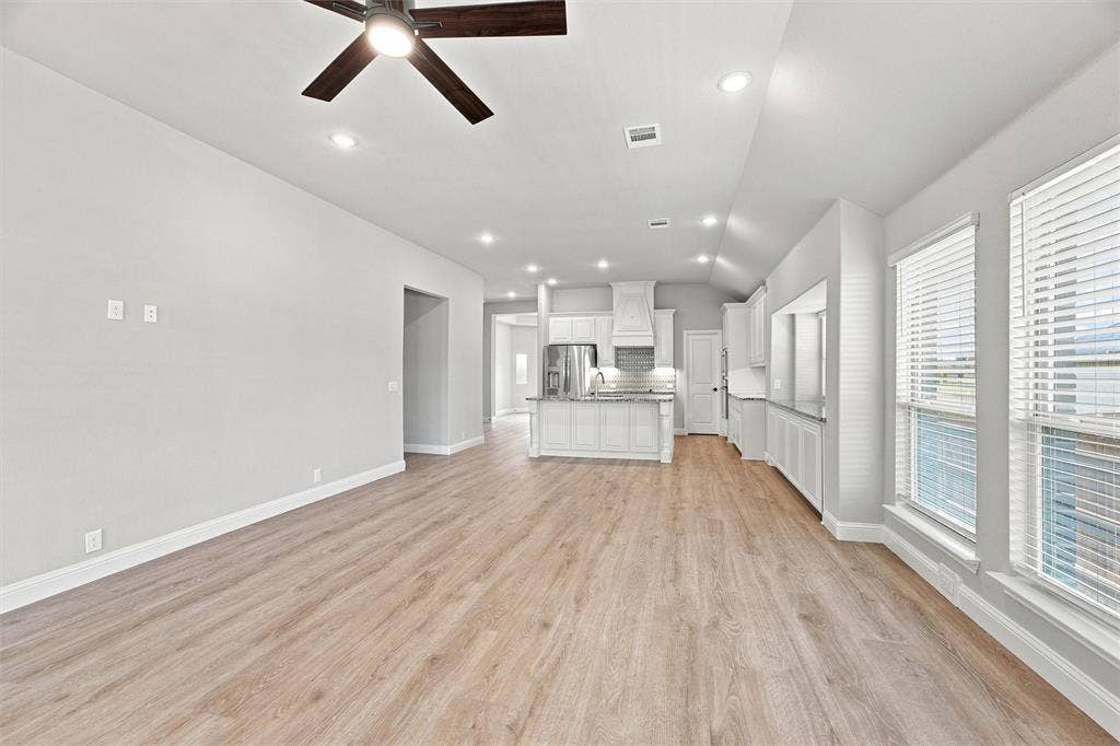 5225 Rowlan Row, Midlothian, TX 76065 Open-concept living area with wood-finish flooring throughout, recessed lighting, and ceiling fan