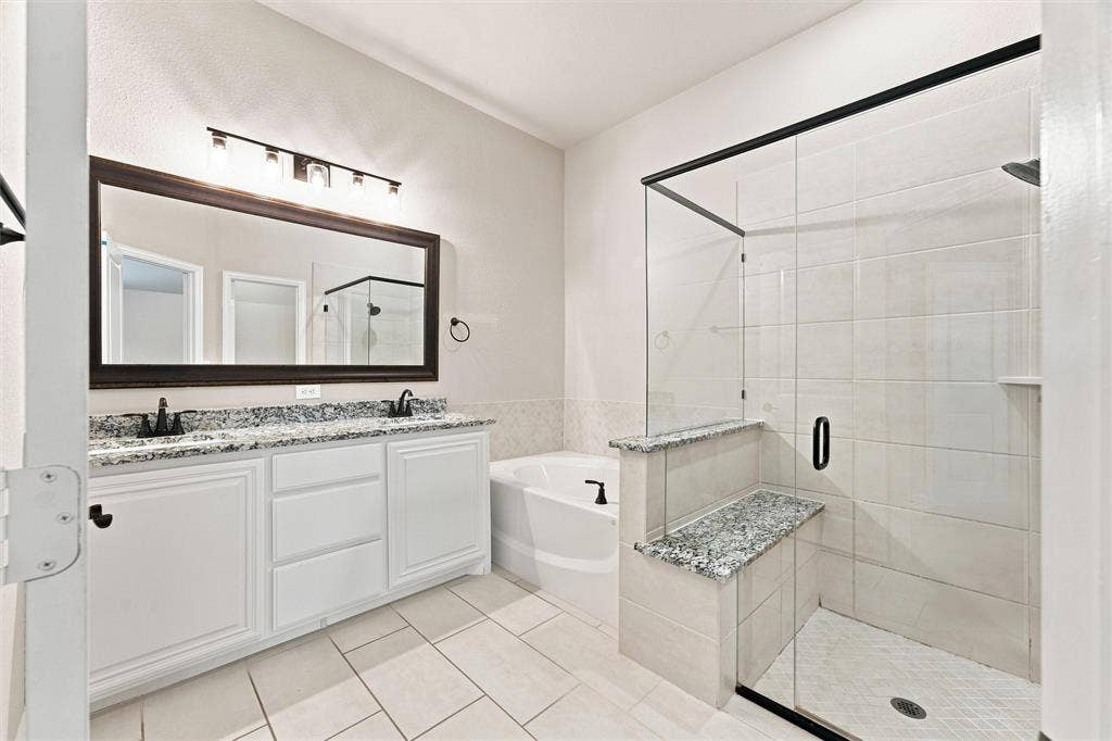 5225 Rowlan Row, Midlothian, TX 76065 Dual vanity with granite countertops, framed mirror, and matte black fixtures