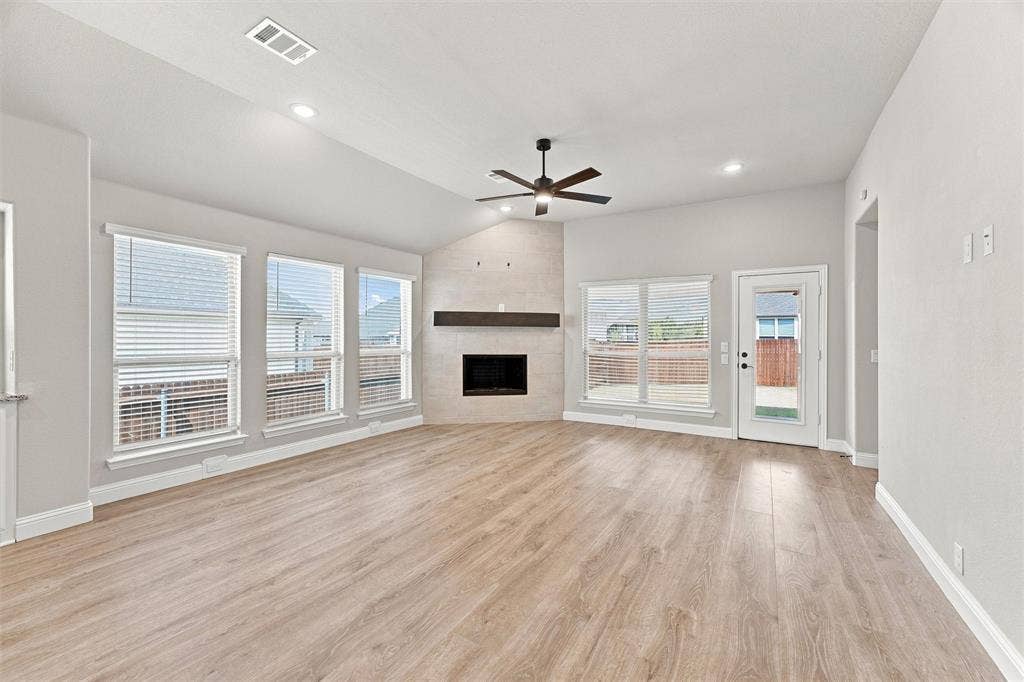 5225 Rowlan Row, Midlothian, TX 76065 Spacious open-concept living area featuring wood-finish flooring throughout, recessed ceiling lighting, and a ceiling fan