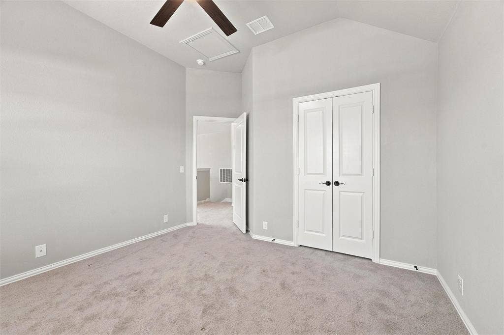 5225 Rowlan Row, Midlothian, TX 76065 Vaulted ceiling with a ceiling fan, light gray wall finish, light gray carpet flooring, and white bifold doors