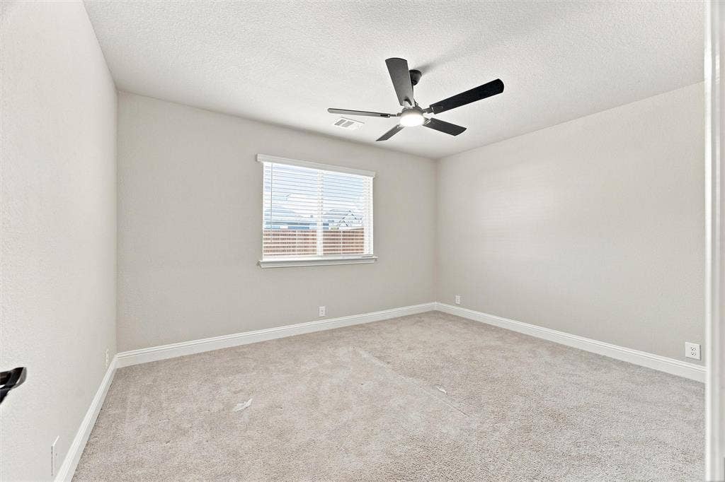 5225 Rowlan Row, Midlothian, TX 76065 Neutral tone wall paint, carpeted flooring, window with blinds, and ceiling fan with integrated lighting