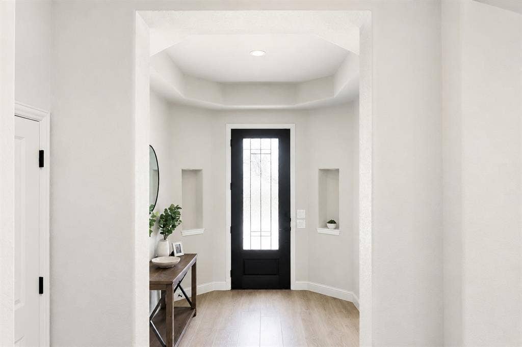 5225 Rowlan Row, Midlothian, TX 76065 Wood-finish flooring leading to a black front door with decorative glass