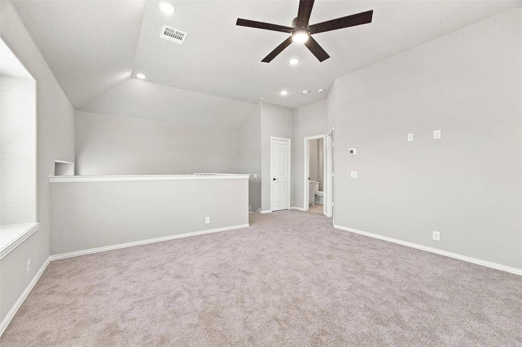 5225 Rowlan Row, Midlothian, TX 76065 Carpeted flooring, vaulted ceiling, recessed lighting, ceiling fan, and built-in shelving