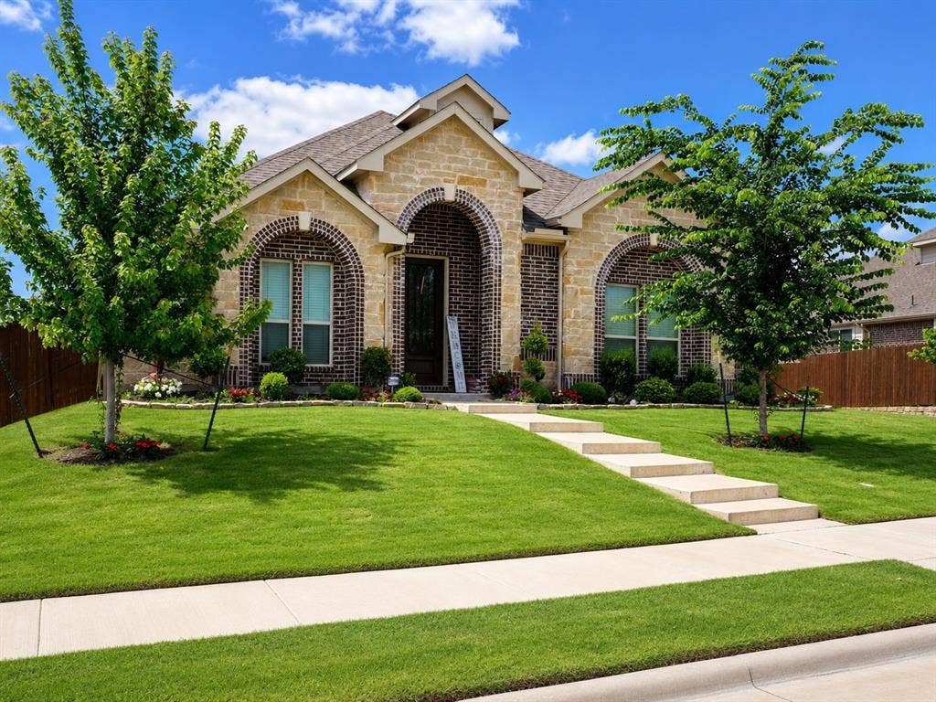 5225 Rowlan Row, Midlothian, TX 76065 Stone and brick exterior with arched entryway, concrete walkway, and established landscaping