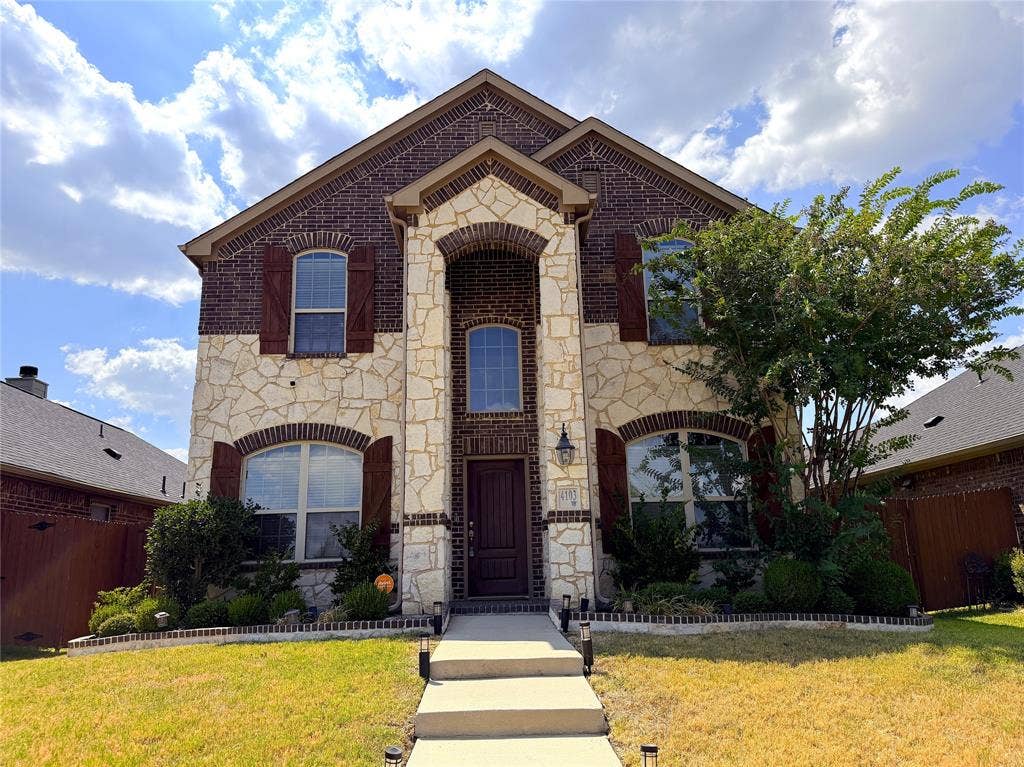 4103 Portrush Drive, Heartland, TX 75126 Stone and brick facade with arched entryway
