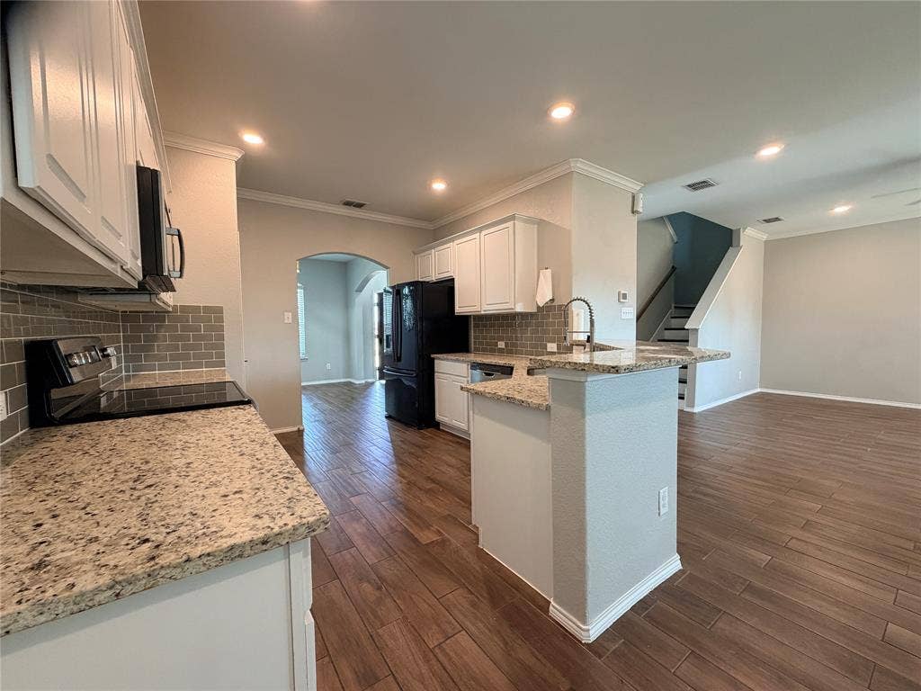 4103 Portrush Drive, Heartland, TX 75126 Kitchen featuring white cabinetry, granite countertops, tile backsplash, built-in appliances, and wood-finish flooring