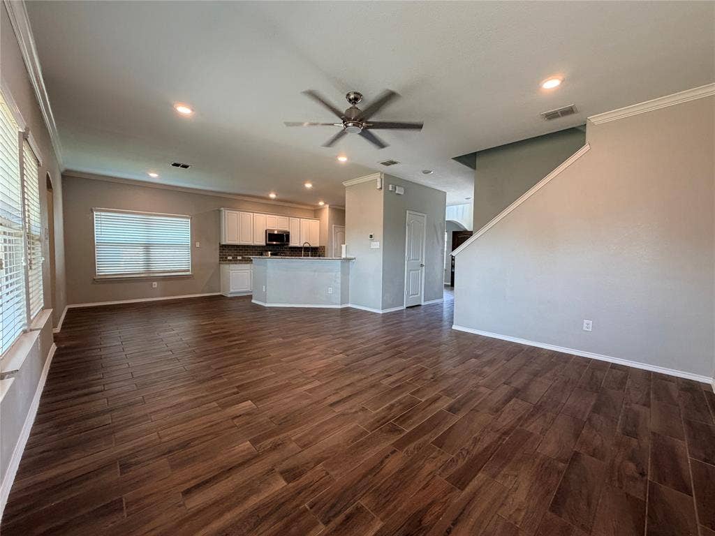 4103 Portrush Drive, Heartland, TX 75126 Expansive open-concept space featuring wood-finish flooring, recessed lighting, and a ceiling fan