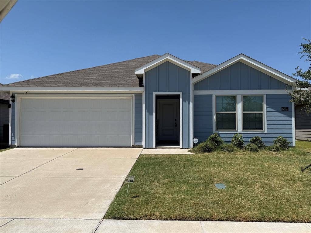 6534 Whitecap Drive, Princeton, TX 75407 Light blue siding exterior featuring a prominent two-car garage