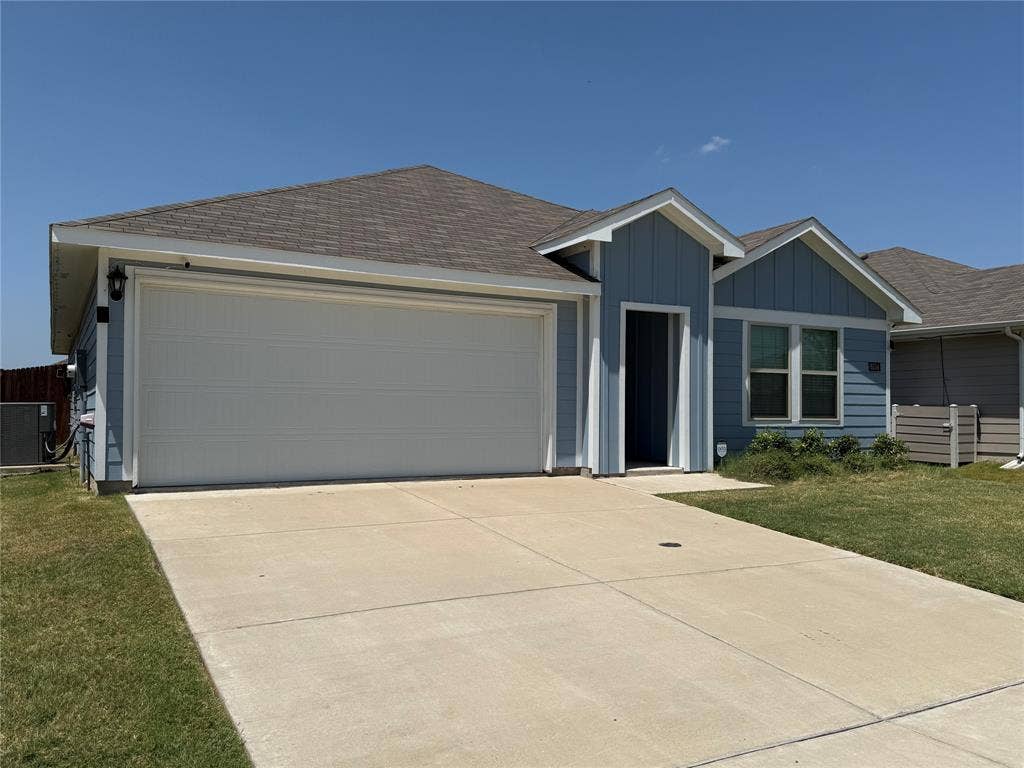 6534 Whitecap Drive, Princeton, TX 75407 Light blue siding exterior with a two-car garage