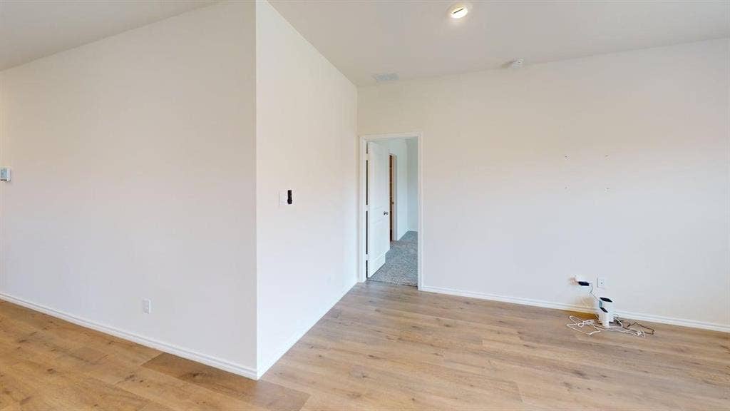 6534 Whitecap Drive, Princeton, TX 75407 Wood-finish flooring, recessed ceiling lighting, and crisp white walls provide a neutral palette