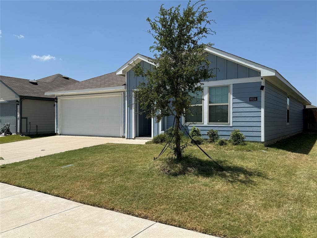 6534 Whitecap Drive, Princeton, TX 75407 Light blue siding exterior with white trim, a single-car garage, and a concrete driveway