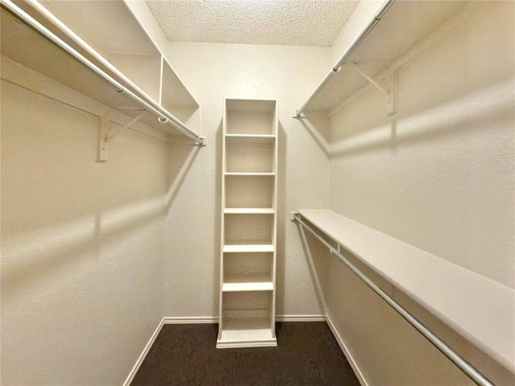418 Newberry Street, Grand Prairie, TX 75052 Built-in shelving, hanging rods, and dark wood-finish flooring