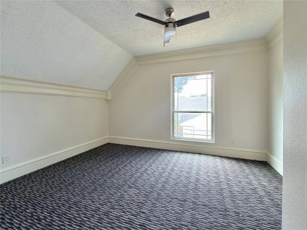 418 Newberry Street, Grand Prairie, TX 75052 Sloped ceiling with crown molding, window with grid panes, ceiling fan, and patterned carpet