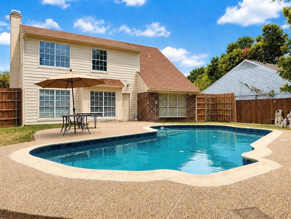 418 Newberry Street, Grand Prairie, TX 75052 In-ground swimming pool with a surrounding textured concrete deck