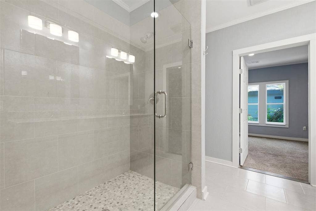 1812 Oneal Street, Greenville, TX 75401 Glass-enclosed shower with a pebble floor and tiled walls