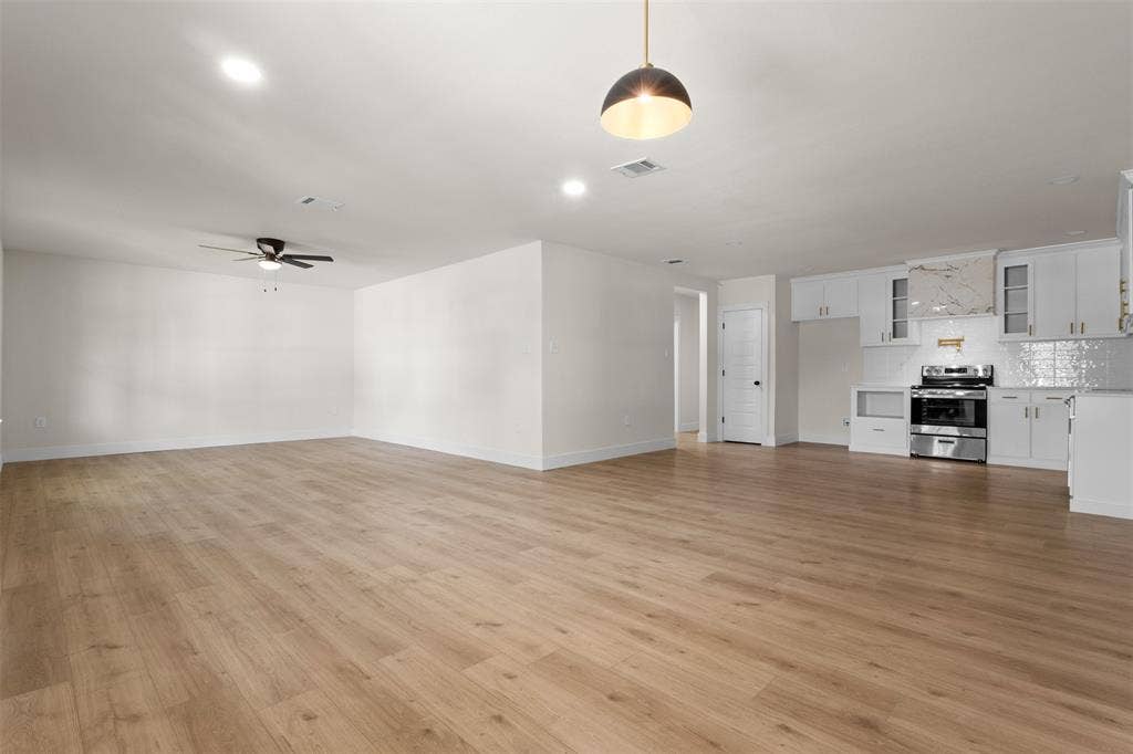 212 E Marguerita Drive, Garland, TX 75040 Open-concept living area featuring wood-finish flooring, recessed lighting, and a ceiling fan
