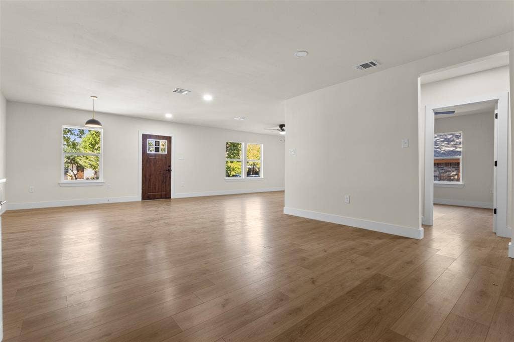 212 E Marguerita Drive, Garland, TX 75040 Expansive room with wood-finish flooring, recessed lighting, and multiple windows