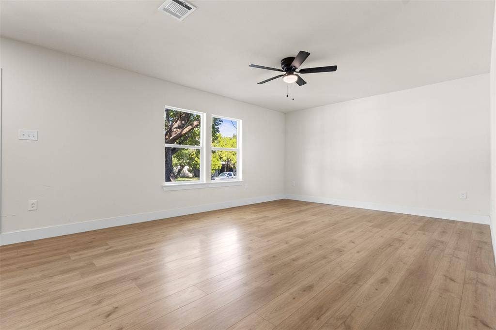 212 E Marguerita Drive, Garland, TX 75040 Wood-finish flooring, white walls, and a ceiling fan with integrated lighting