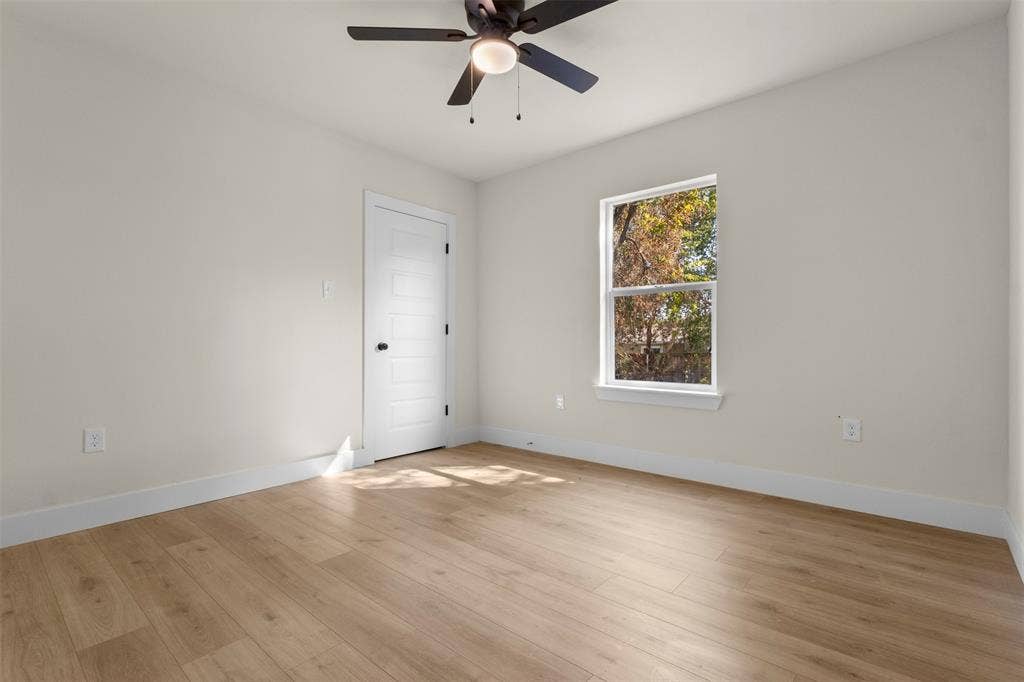212 E Marguerita Drive, Garland, TX 75040 Wood-finish flooring throughout, bright window, ceiling fan with integrated lighting, and a paneled interior door